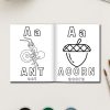 An open page from 78 Preschool Alphabet Coloring Pages displays an ant and an acorn with uppercase and lowercase A, plus the words ant and acorn. Art supplies, a keyboard, and a coffee cup are nearby.